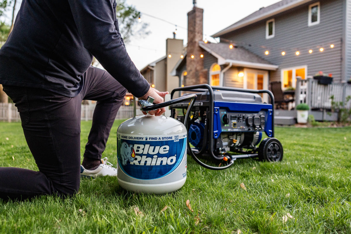 A man hooking up a fresh Blue Rhino to a generator in the backyard.
